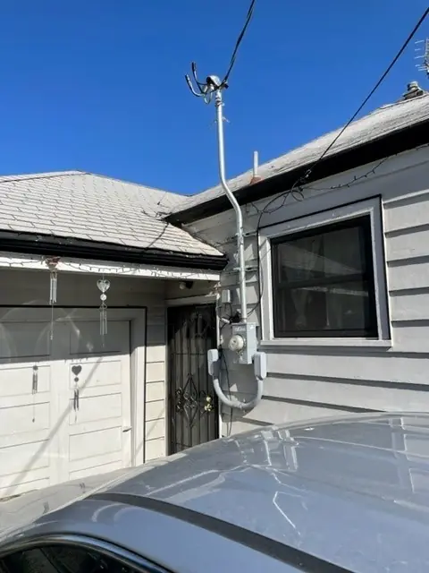 Overhead service mast and meter on a house upgraded by Castle