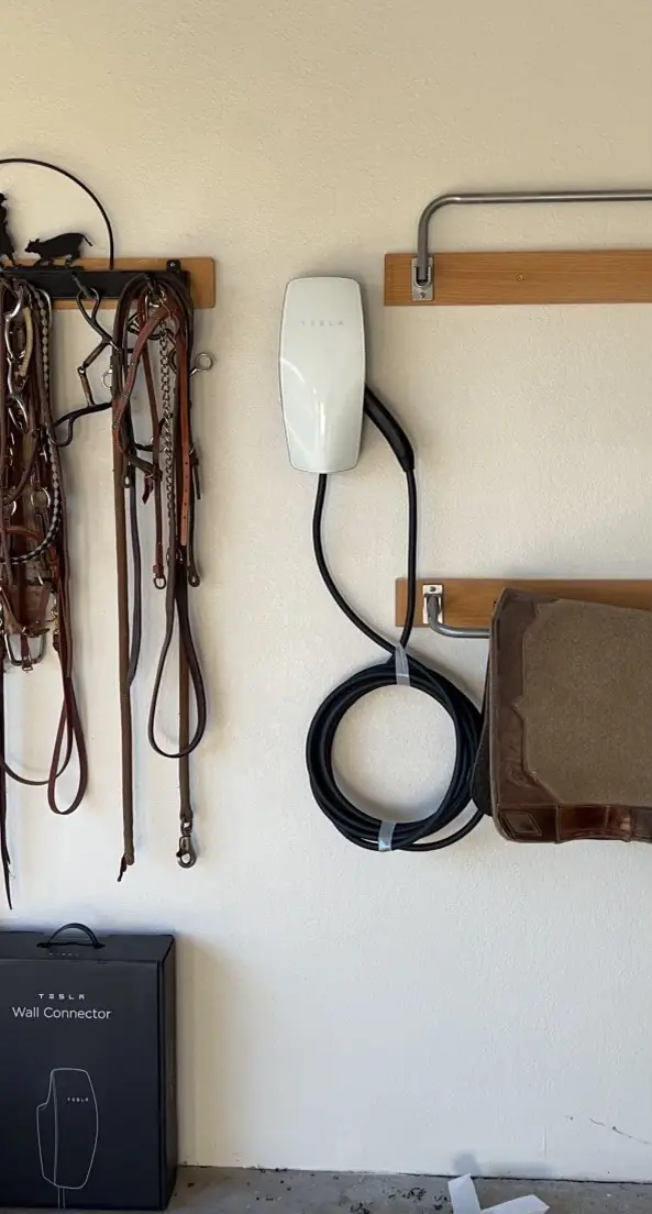 Tesla wall connector installed by Castle on a tack room wall