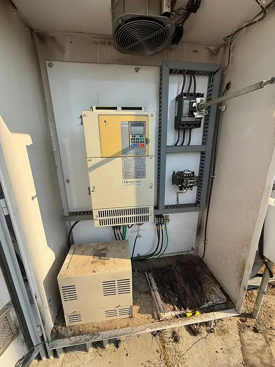 Open pump control cabinet with a variable frequency drive and transformer wired by Castle